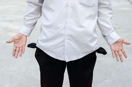 Business man showing his empty pocketの写真素材