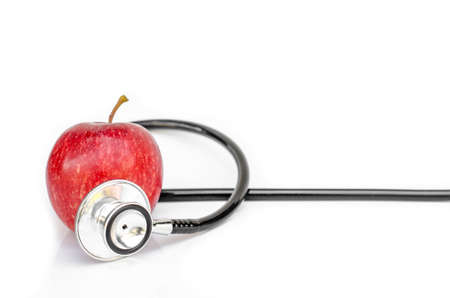 Red apple and Medical stethoscope isolated on white backgroundの写真素材