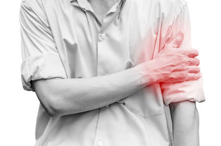 Young attractive business man having shoulder pain isolatedの写真素材