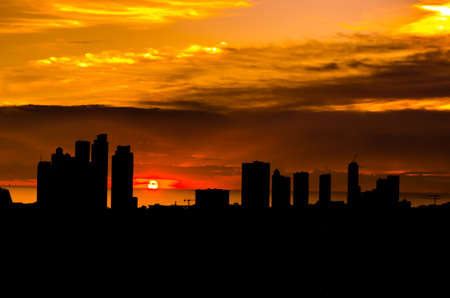 Backlight of a building city in a beautiful sunsetの写真素材