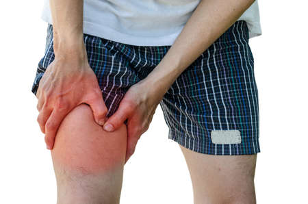 man with leg calf pain isolated on pure white backgroundの写真素材