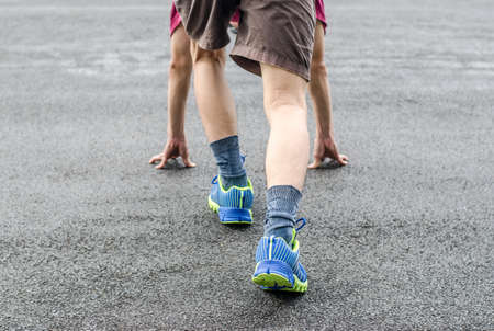 get ready to run. Male runner is about to start to runの写真素材