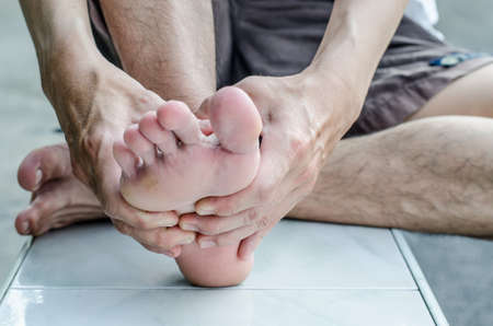 Man's hand being massaged a footの写真素材