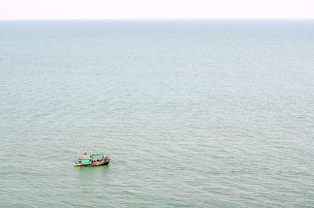 Fishermen on small boat in the sea at thailandの写真素材
