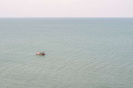 Fishermen on small boat in the sea at thailandの写真素材