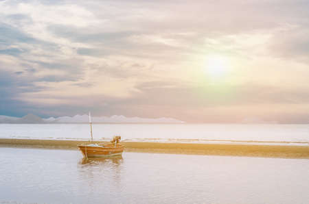 boat on the beach with sunset at Huahin in Thailandの写真素材