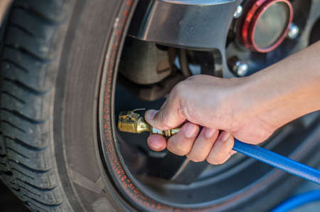 Filling air into a car tire in pump.の写真素材