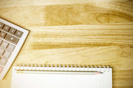 notebook and pencil with calculator on the deskの写真素材