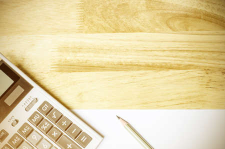 Blank white paper is on the table with calculatorの写真素材