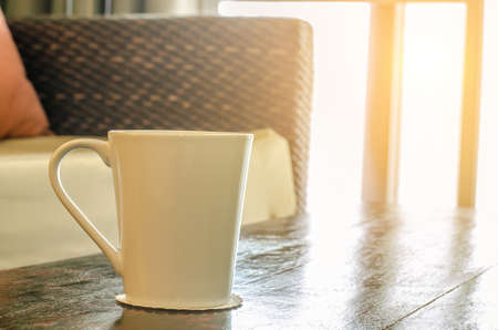 cup of tea on table beside sofaの写真素材