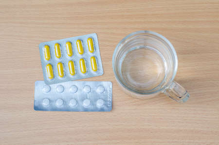 Water in glass and Drug on table background - for take a medicineの写真素材