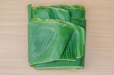 banana leaf folded on wood tableの写真素材