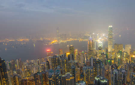 Hong Kong the scenes, victoria harbour from the peak bird view, in the mist with bad weather in the night, nimbus landscape on the trailsのeditorial素材