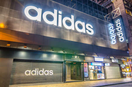 Hong Kong - December 7th, 2016. a closed Adidas' shop at night outside the store.のeditorial素材