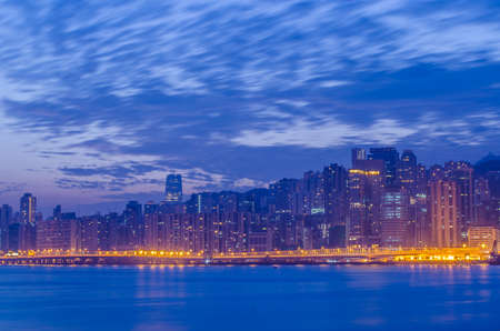 City of Hong Kong with water front with sunrise sky backgroundの写真素材
