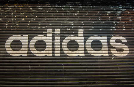 Hong Kong - December 7th, 2016. a closed Adidas' shop at night outside the store.のeditorial素材
