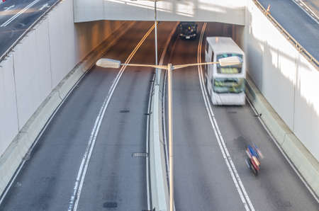 two cars  and motorcycle outing the highway tunnel in morning, Hong Kongの写真素材