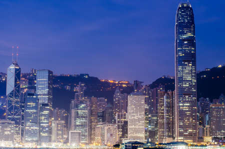 Hong Kong city office building over Victoria bay during sunriseの写真素材