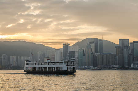 HONG KONG - December 10:Star ferry in Victoria Harbor and HK skyline at sunrise. View from Kowloon on Hong Kong Island on December 10, 2016のeditorial素材