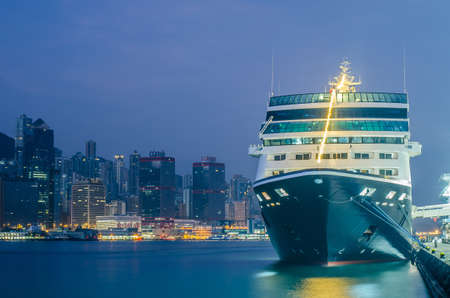 HONG KONG - December 10 ,2016: Cruise ship dock embarkment Port Ocean Terminal in Victoria Harbour and Hong Kong Skyline Cityscape at sunrise from Tsim Sha Tsuiのeditorial素材