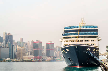 HONG KONG - December 10 ,2016: Cruise ship dock embarkment Port Ocean Terminal in Victoria Harbour and Hong Kong Skyline Cityscape at sunrise from Tsim Sha Tsuiのeditorial素材