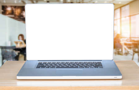 laptop computer with blank screen over wooden table indoor and blurred backgroundの写真素材