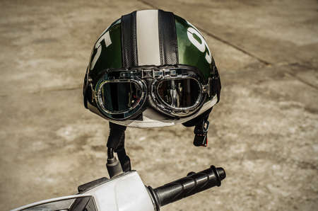 Motorcycle on the road with a helmet on the handlebars.の写真素材