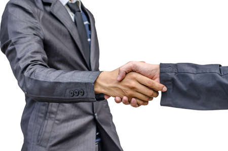 Closeup of two businessmen shaking hands against white backgroundの写真素材