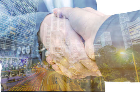 Closeup of two businessmen shaking hands against white backgroundの写真素材