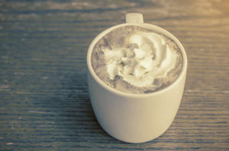 Coffee cup on table in coffee shop - vintage style effect pictureの写真素材