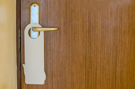 Door of hotel room with empty sign please do not disturbの写真素材