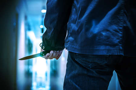 Evil criminal with sharp knife ready for robbery or to commit a homicide with clipping pathの写真素材