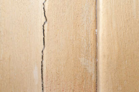 decayed and broken internal wall of the old house with the peeled-off yellow paintの写真素材