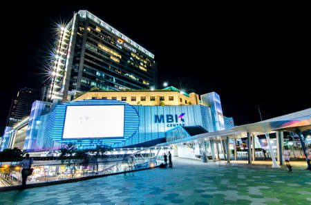 Bangkok,Thailand - 2 November 2017 : Night light with long speed shutter of traffic at MBK, BTS Siam interchange in front of Siam Discovery and Art Museum junction.This place is very famous shopping mall at central of Bangkokのeditorial素材