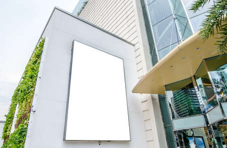 Blank advertising billboard in metallic frame with spotlight on department store  building in the city, useful for advertisementの写真素材