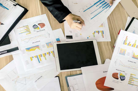 business documents with charts growth, keyboard and pen with tablet. business conceptの写真素材