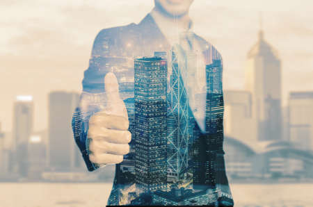 Happy business man holding his thumbs up isolated over white backgroundの写真素材