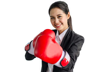 Portrait of beautiful and young business woman wearing boxing gloves Isolated on the white background.の写真素材