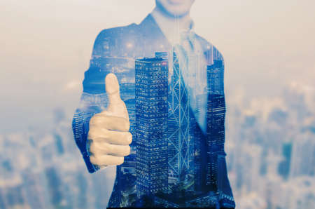 Happy business man holding his thumbs up isolated over white backgroundの写真素材