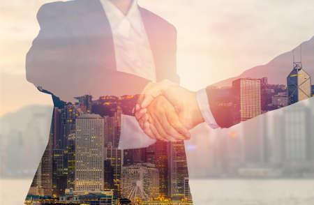 Business handshake. Two businessman and business women shaking hands isolated on white backgroundの写真素材