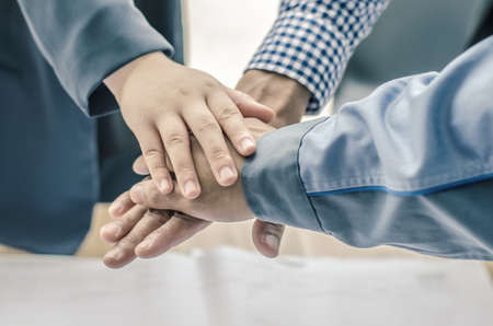business, building, partnership, gesture and people concept , stacking hands express their teamwork and cooperationの写真素材