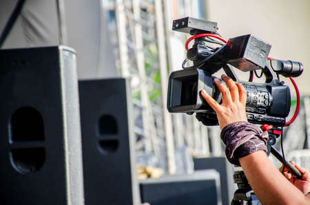 Accessories for 4k TV camera in a concert hall with laser lighting. Professional digital video...