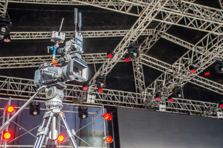 Accessories for 4k TV camera in a concert hall with laser lighting. Professional digital video camera.のeditorial素材
