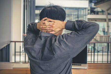 businessman relaxing neck - short break for exercise in office
