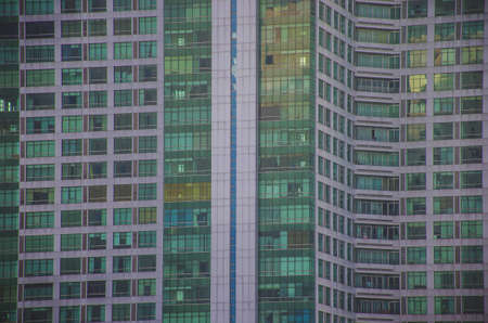 Skyscraper windows glow at evening. Modern hotel building , Windows background.