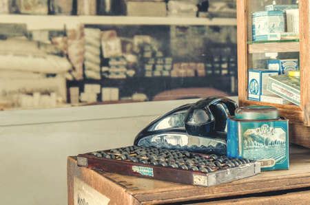 THAILAND, BANGKOK â 21 JUNE, 2018: Vintage telephone and abacus on wooden and medicine cabinet backgroundのeditorial素材