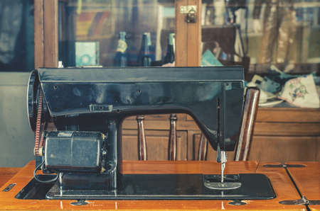 View black retro sewing machine in an old house