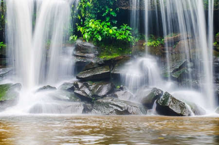 cold river waterfall cascade falling down on stones in national reserve park Thailandの写真素材