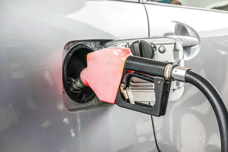 Add fuel oil to the car in the fuel gas station with a dispenser.(select focus).