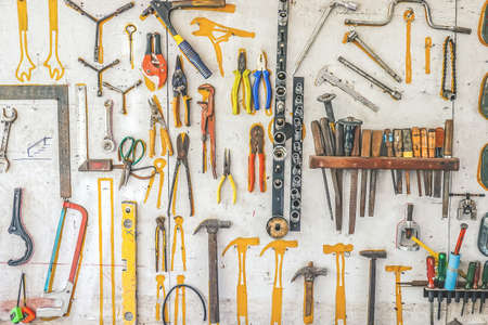 Many different rusty old tools hanging on a wallの写真素材
